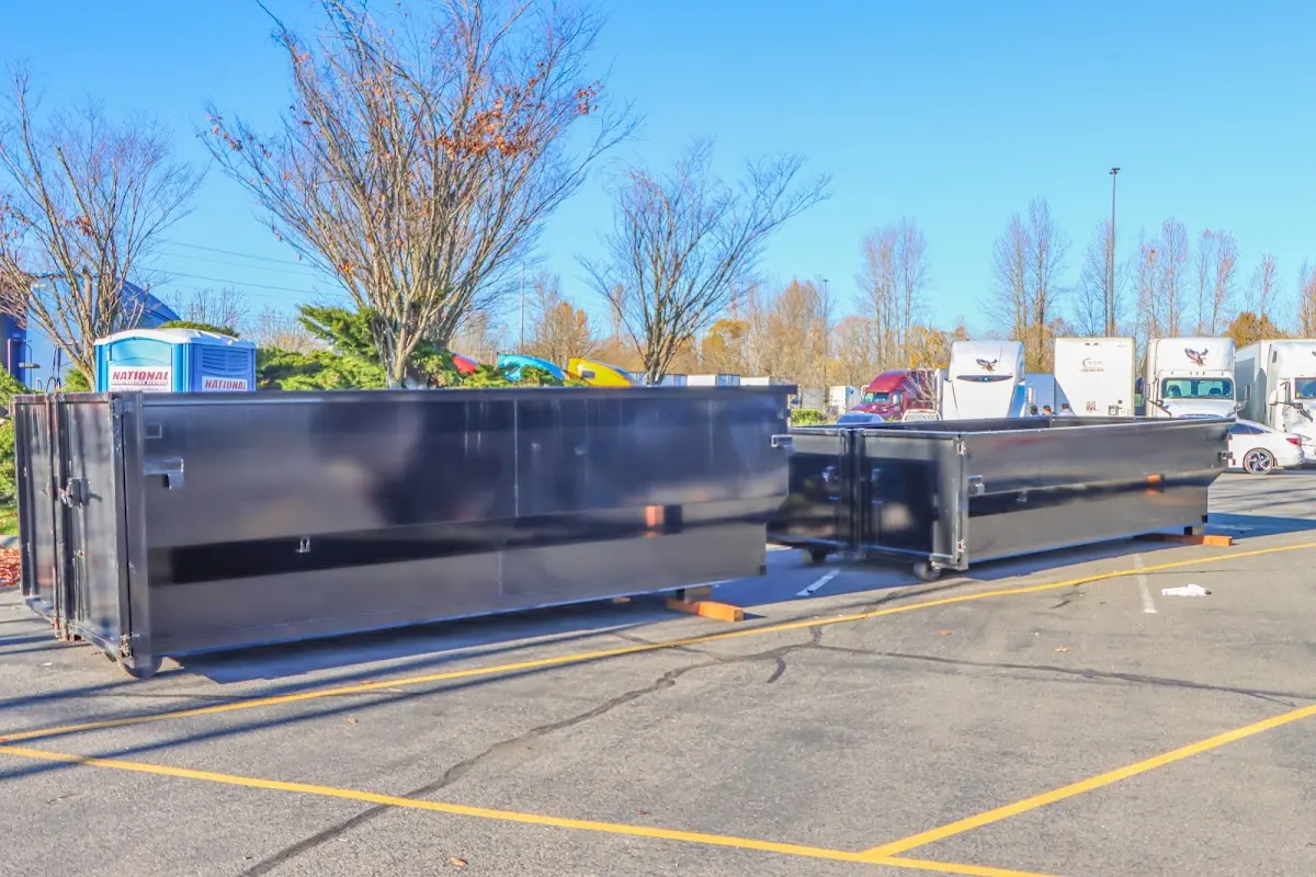 Professional dumpster rental service with roll-off container on residential driveway in Fountain Valley